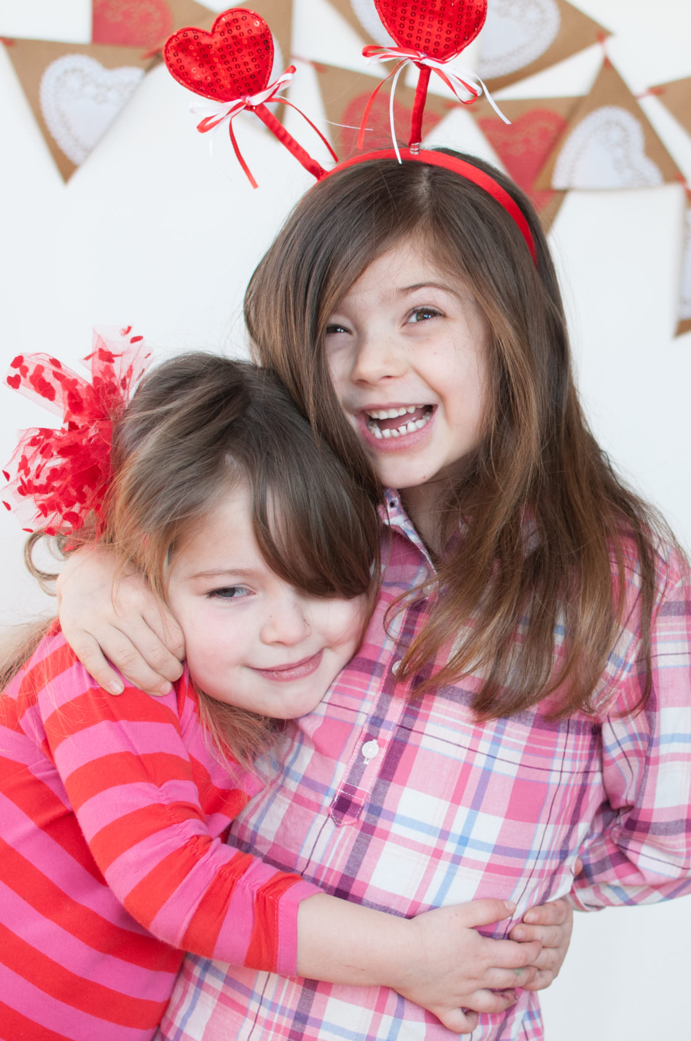 two valentines sisters hugging, Northville Child Photographer