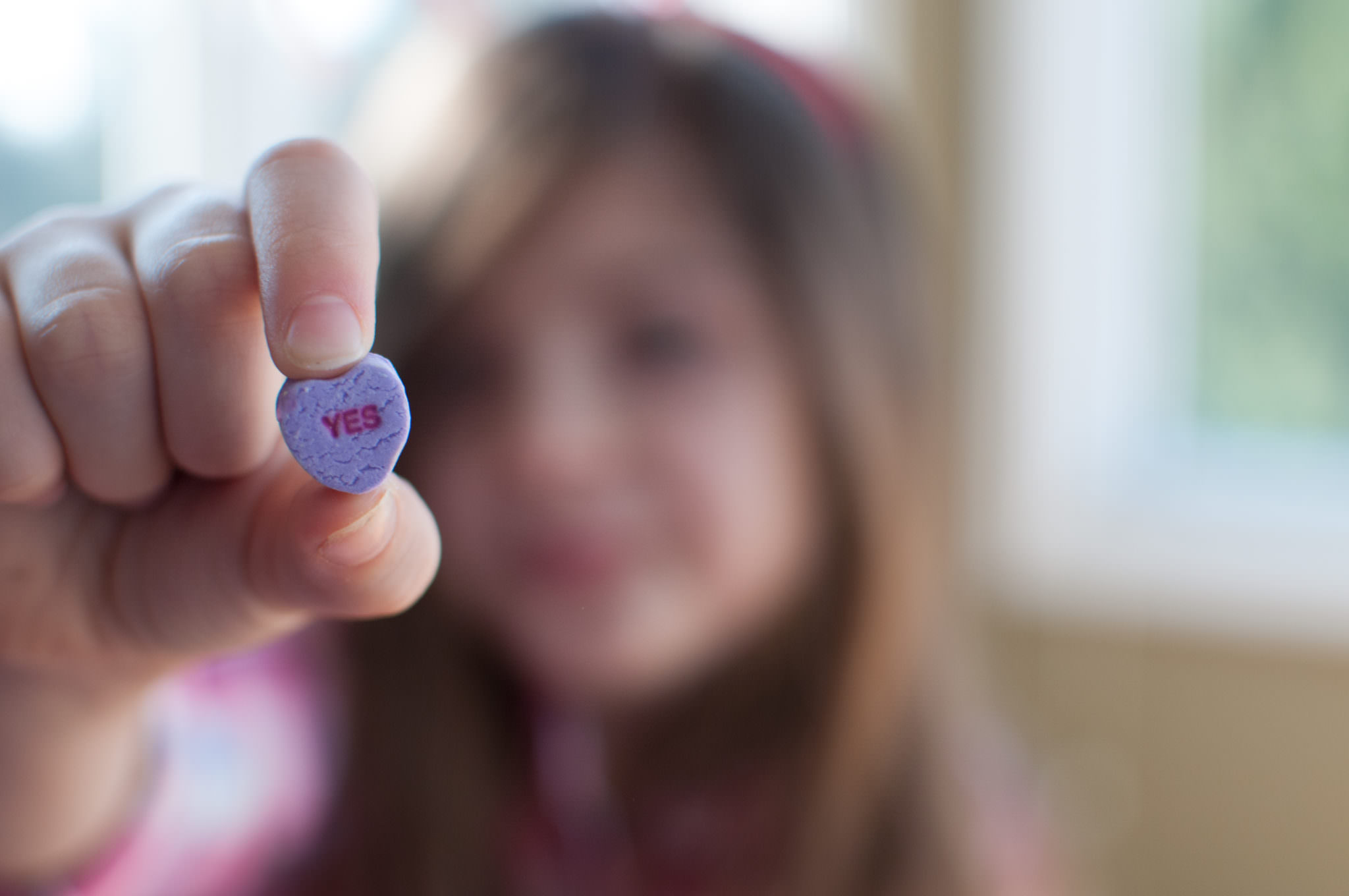 Girl holding Yes Conversation Heart, Valentine's Day Photography