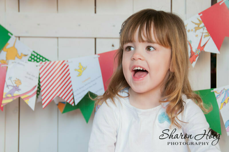 Young girl laughing at someone off camera, Northville Child Photographer