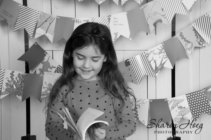Young girl flipping through a book, Metro Detroit Child Photographer
