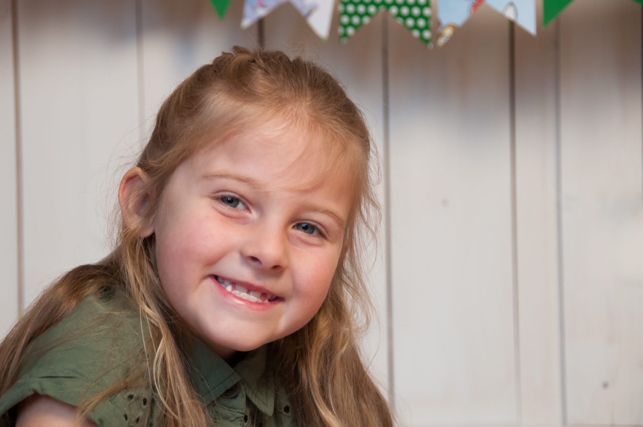 first grader smiling at camera, Northville Child Photography