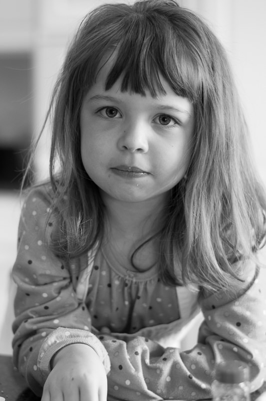 serious faced girl baking in the kitchen, Livonia Child Photography