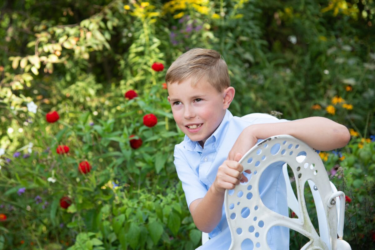 boy sitting on a butterfly chair during photoshoot in metro detroit