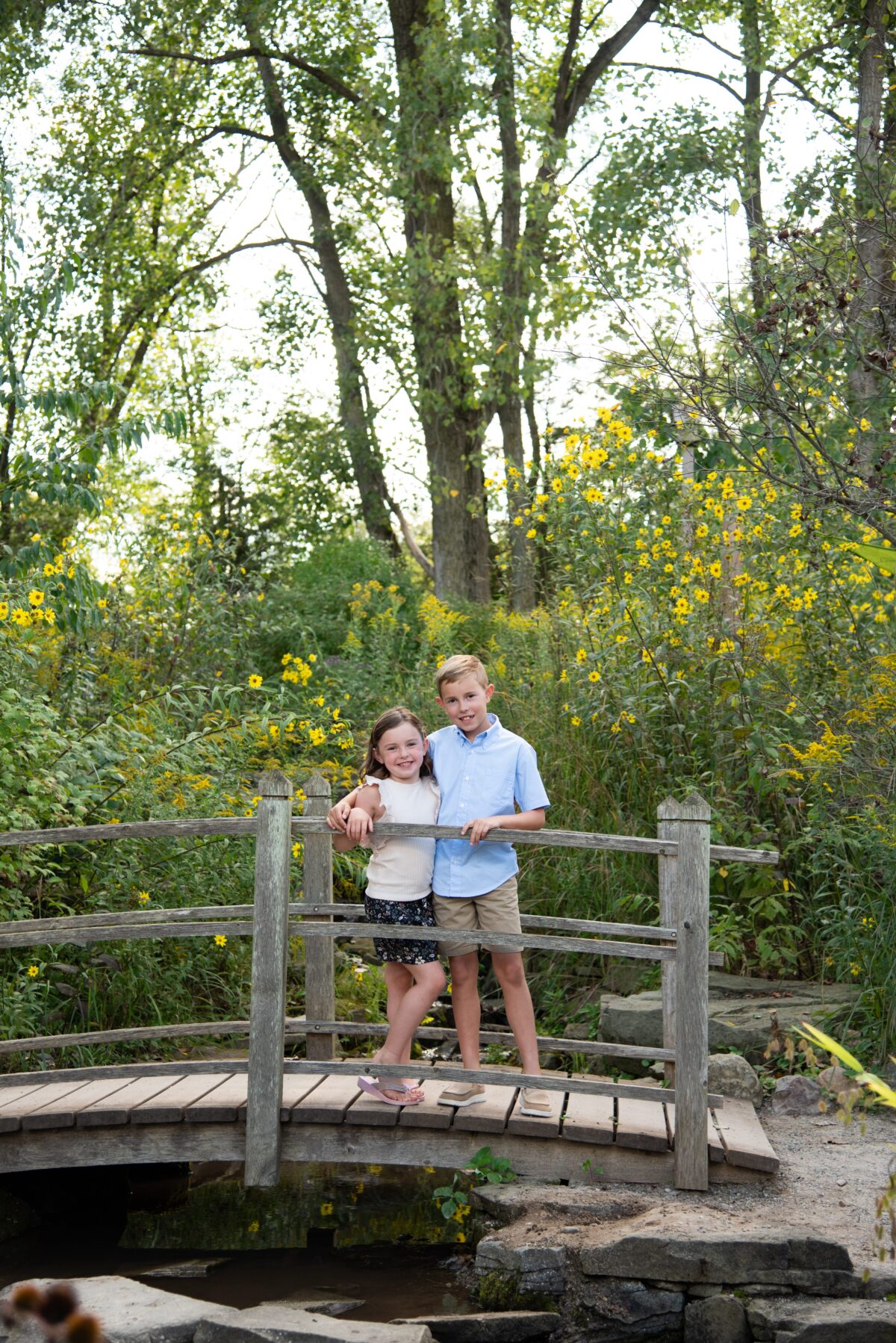 siblings hugging on a bridge during photo session in detroit