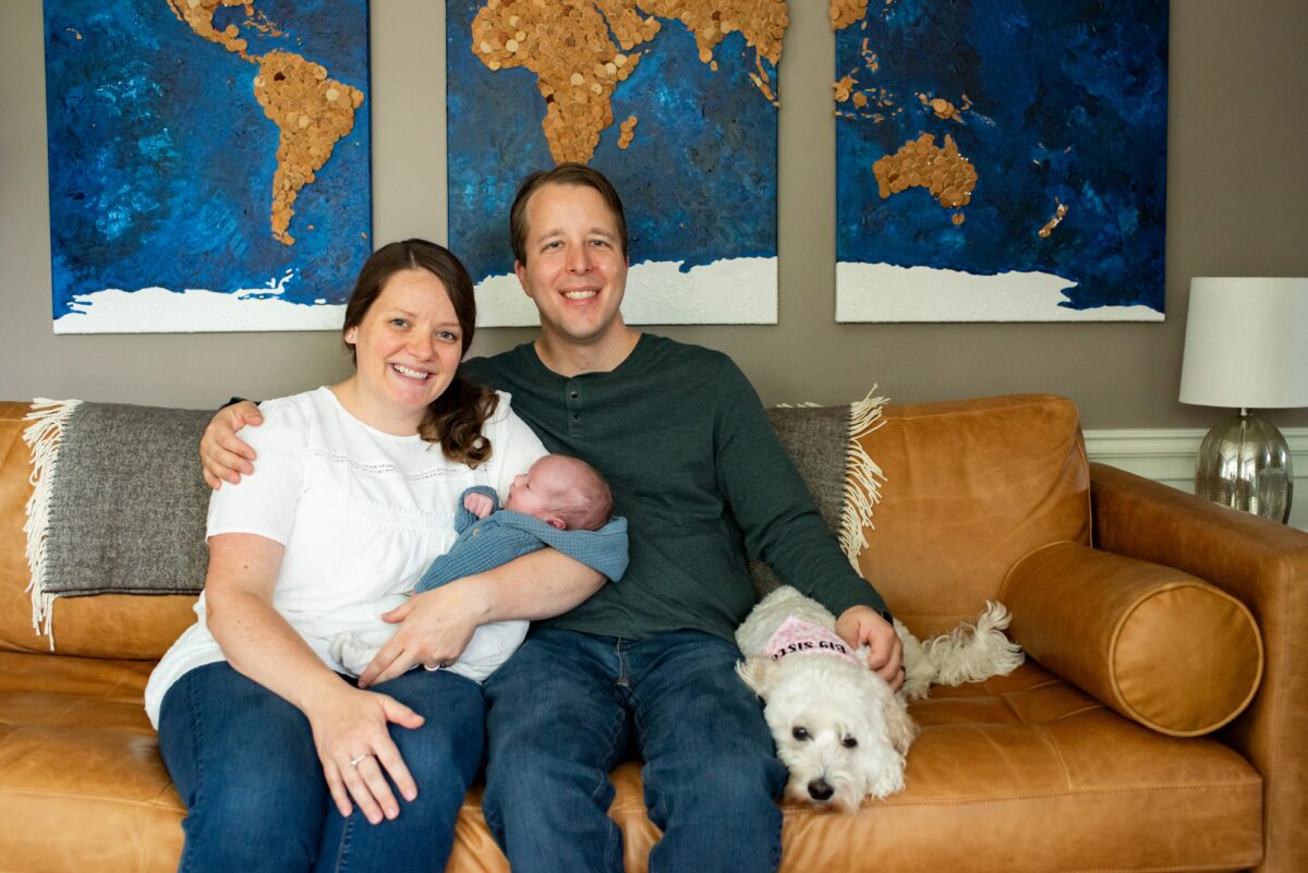 Royal Oak family poses with new baby and puppy on couch